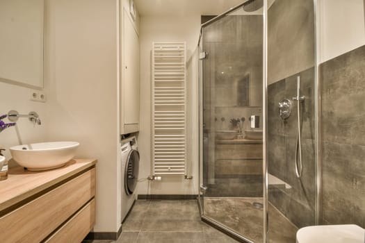 a bathroom with a shower sink and a washing machine