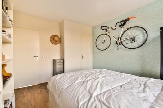 a bedroom with a bed and a bicycle hanging on