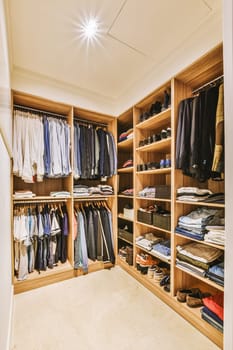 a walk in closet with wooden shelves and a ceiling