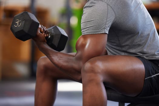 Dumbbell, power and black man doing a workout in the gym for intense arm strength training. Sports, motivation and strong African male bodybuilder doing a exercise with weights in a sport center.