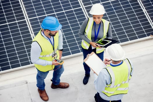 Top view, engineer teamwork and planning of solar panel maintenance, inspection or installation. Solar energy, renewable energy and group of contractors with tablet, tech or checklist in discussion.