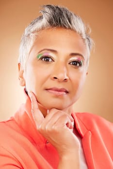 Makeup, creative and senior woman with fashion, beauty and designer luxury against a brown studio background. Stylish, retirement and portrait of elderly model with an idea for cosmetics and style.
