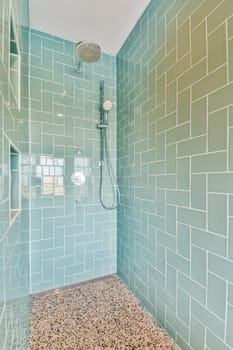 a blue subway tile shower with a shower head in