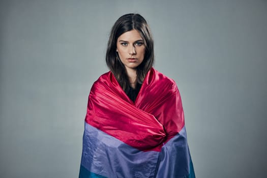 Bisexual flag, pride and woman in portrait, lgbtq and freedom to love, inclusion and equality, protest for human rights. Gay, trans and lesbian identity, politics and community on studio background