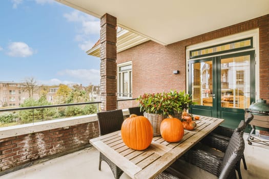 a porch with a table with pumpkins on it