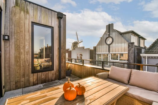 a deck with a table with pumpkins on it
