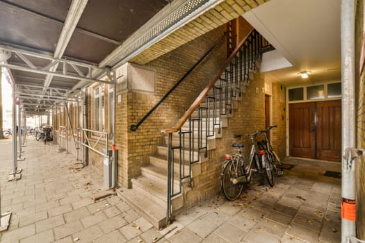 the entrance to a building with a staircase and bikes