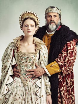 Costume, portrait and king and queen in crown isolated on studio background for medieval, renaissance and fashion history. Headshot of royal couple hug with power, wealth and vintage culture and love
