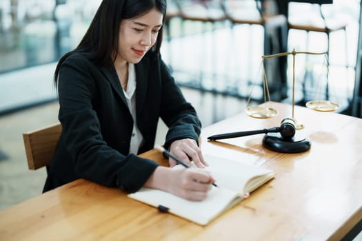 Portrait of a beautiful Asian lawyer studying a lawsuit for a client before going to court
