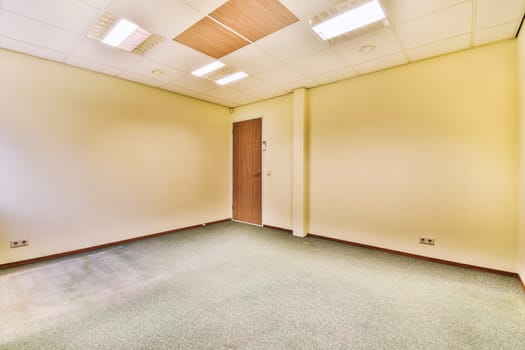 an empty room with a door in the corner