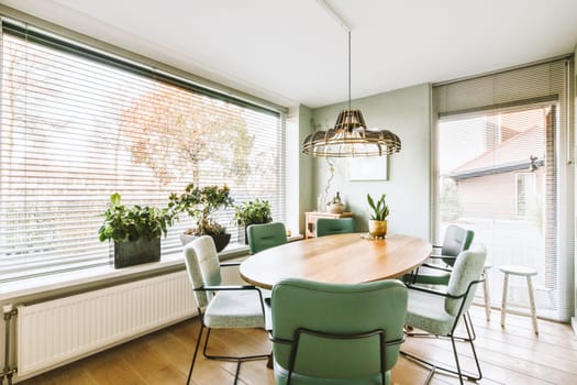 a dining room with green chairs and a wooden table