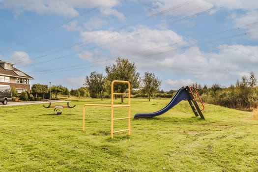 a playground with a slide in a field