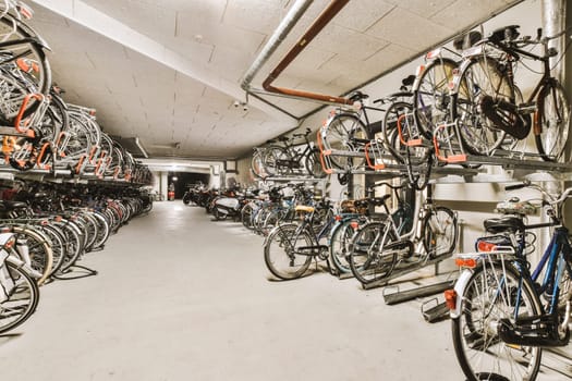 a lot of bikes are hanging on the wall in