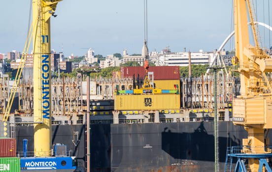 Montevideo, Uruguay - 5 February 2023: Containers being loaded onto ship in commercial port