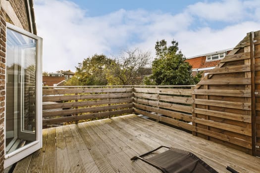 a deck with a wooden fence and a window