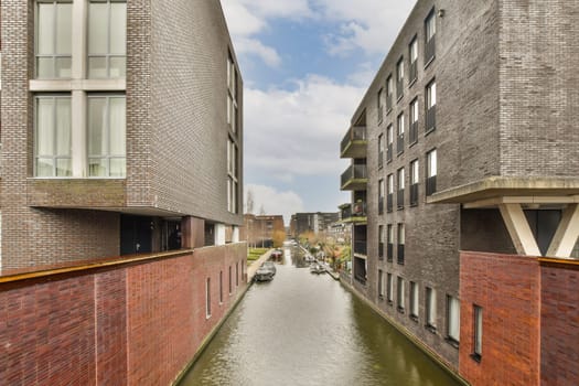 a canal between two buildings with a boat in it