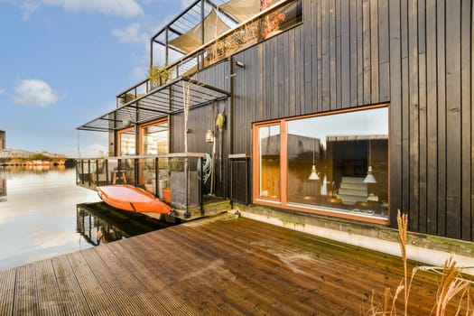 a shipping container home with a boat on the water