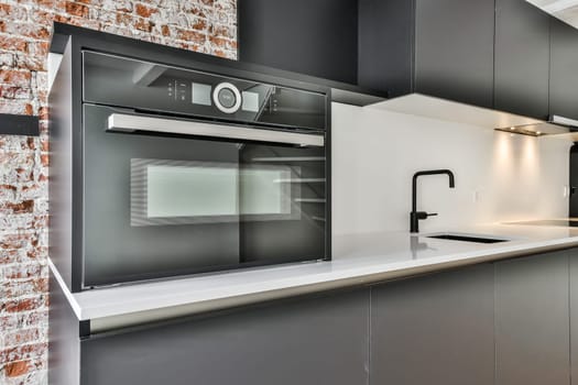 a black and white kitchen with a black microwave oven