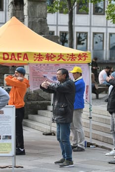 Vertical shot of people demonstrating in Cologne against organ trafficking of Falun Gong members