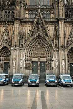 Row of Mercedes-Benz Sprinter police cars in front of Cologne Cathedral in Germany