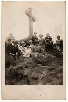 THE CZECHOSLOVAK REPUBLIC - CIRCA 1940s: Vintage photo shows people on trip. People sit at the Christian cross.