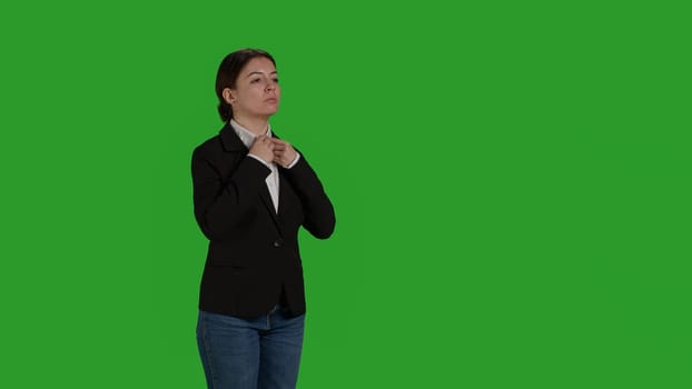 Side view of businesswoman standing on green screen backdrop