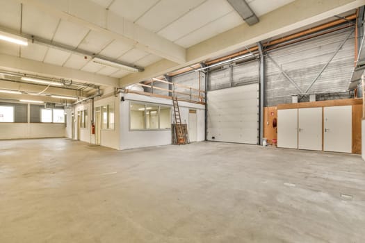 the interior of a warehouse with white walls and doors