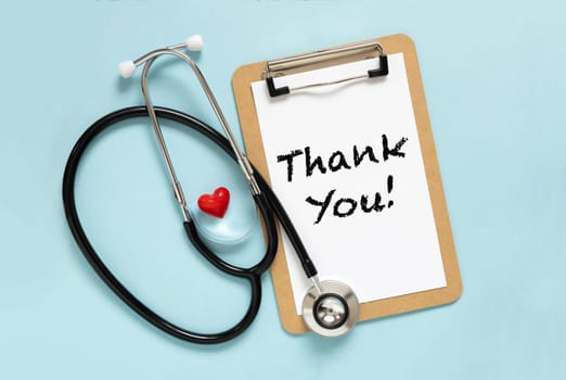 Text Thank you International nurses week concept. Congratulation for nurse day. Flat lay stethoscope, red heart on pastel blue background.