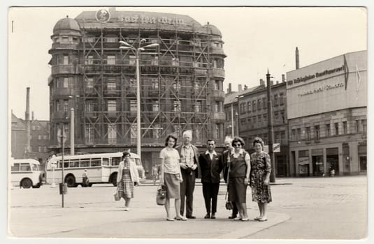 Vintage photo shows group of people in unknown town in Germany (GDR).