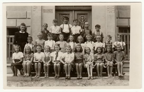 THE CZECHOSLOVAK SOCIALIST REPUBLIC - CIRCA 1948: Vintage photo shows pupils (schoolmates) and their female teacher.
