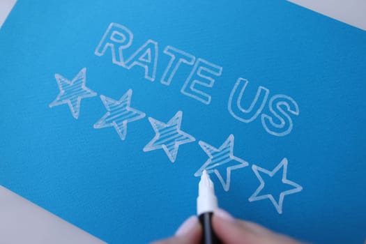 Handwritten review rate us and star rating on blue background