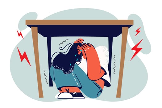 Woman sobs and hides under table in horror during panic attack due to regular stress