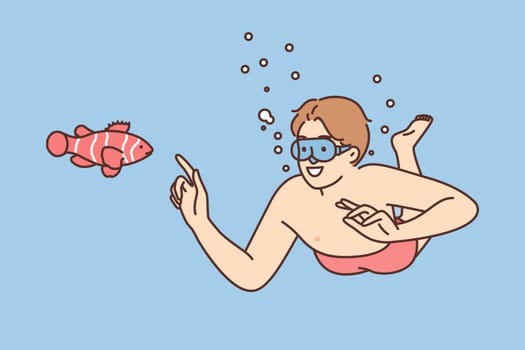 Smiling man in goggles swim underwater