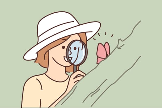 Smiling woman with magnifier look at butterfly