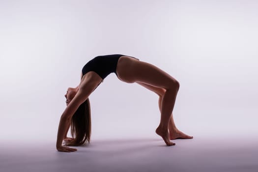 Athletic woman in swimsuit, doing yoga, push-ups, beautiful female exercising at studio