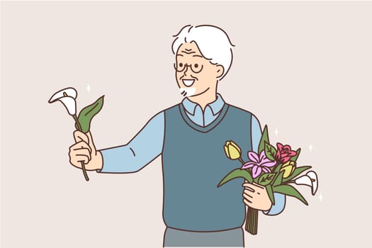 Smiling elderly man greeting with flower