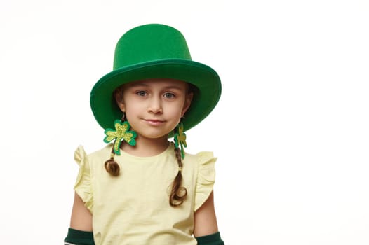 Close-up portrait of smiling Irish little Leprechaun child girl in Saint Patrick carnival clothes, isolated on white