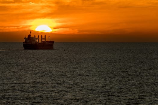 Sunset over the deck of a bulk cargo carrier at sea