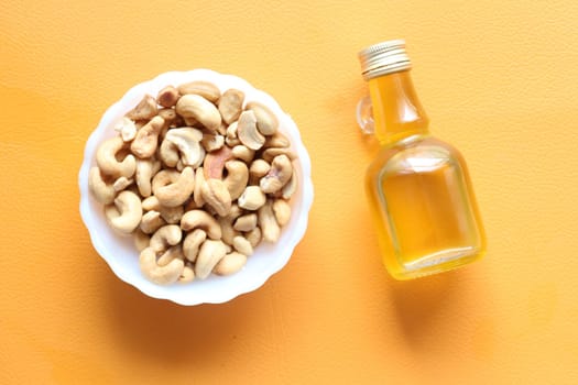 cashew nuts oil on a orange background