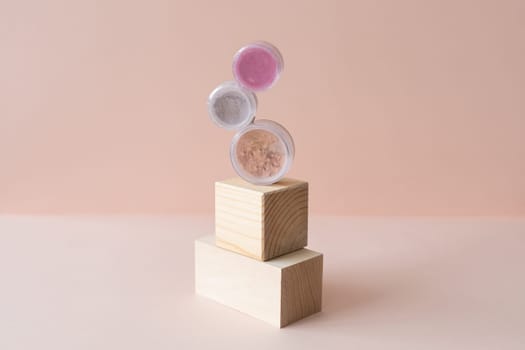 Makeup mineral eco face powder products on pastel background. Eco friendly cosmetics. Eyeshadows and blush