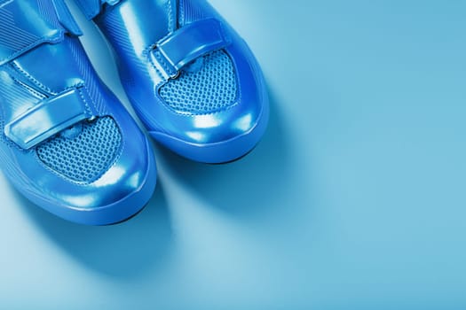 Blue highway cycling shoes on a blue background