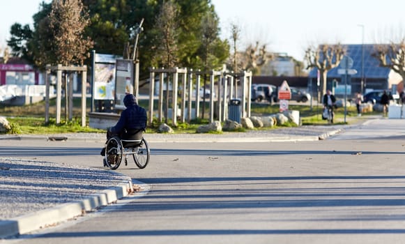 person in a wheelchair on the road