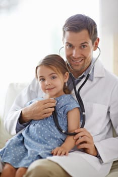 Lets listen to that heart. an adorable young girl with her pediatrician.