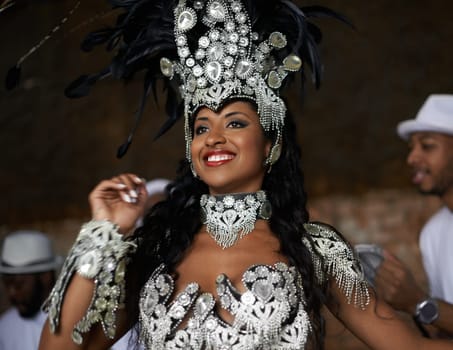 Shes a glamourous dancing queen. a beautiful samba dancer performing in a carnival with her band.