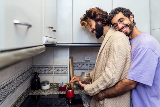 men in love hugging while preparing coffee