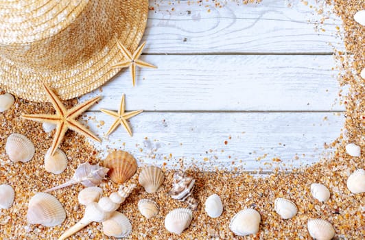 Sand seashells background. Summer time concept with sea shells and starfish on wooden background and sand