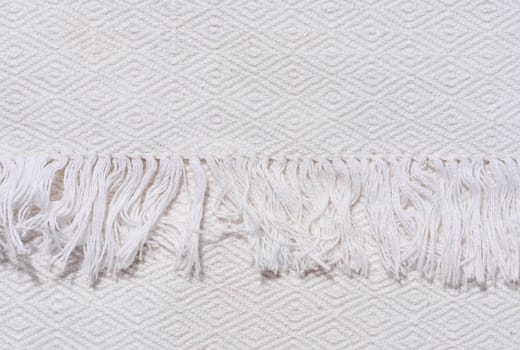 Fragment of a kitchen towel with a fringe
