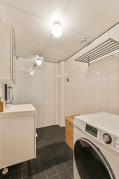 a laundry room with a washing machine and a sink