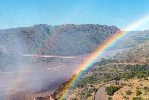 Bridge over Orange River below Gariep Dam behind double rainbow