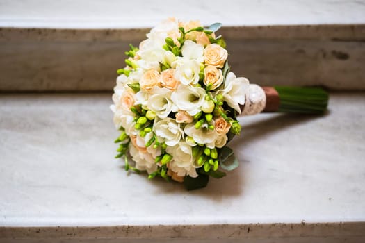 beautiful wedding bouquet on marble staircase